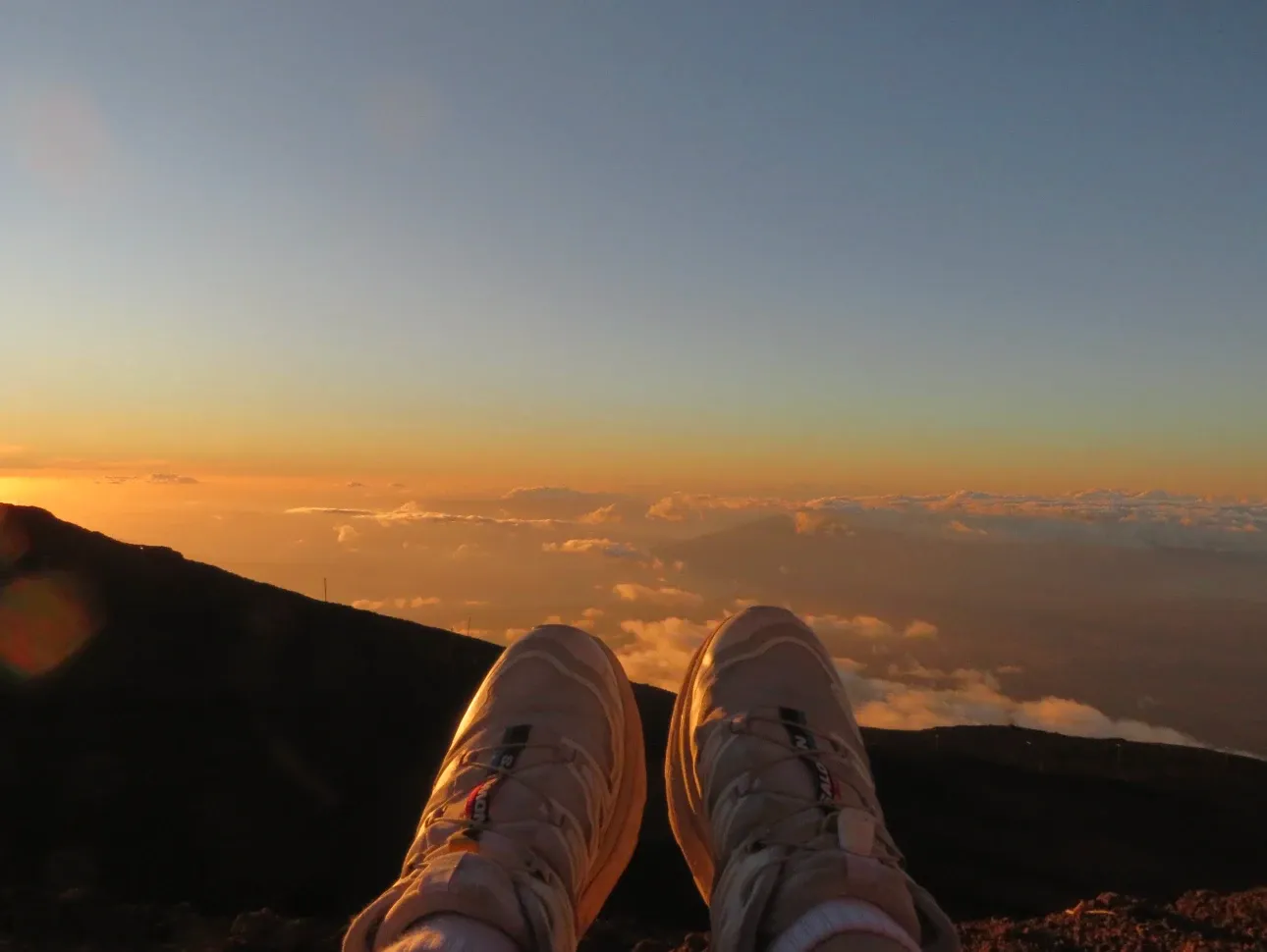 Feet above a sea of clouds at sunset